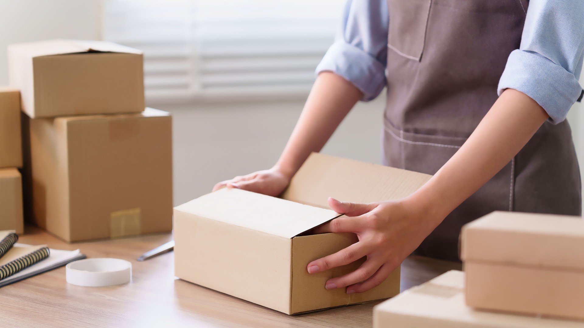 Asian Adult Woman Packing Cardboard Box for Delivery Shipping Service Small Business Owner Preparing Package for Client Order Online Store